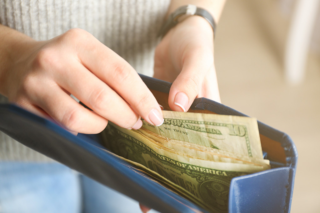 woman paying with cash