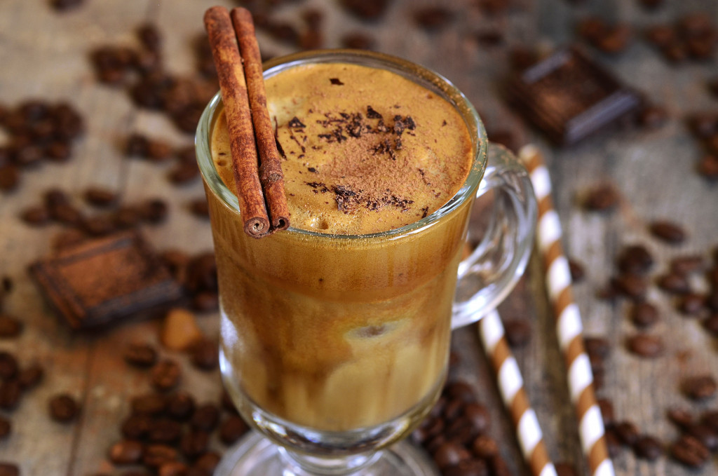 Coffee frappe in a mug with bread sticks on top.