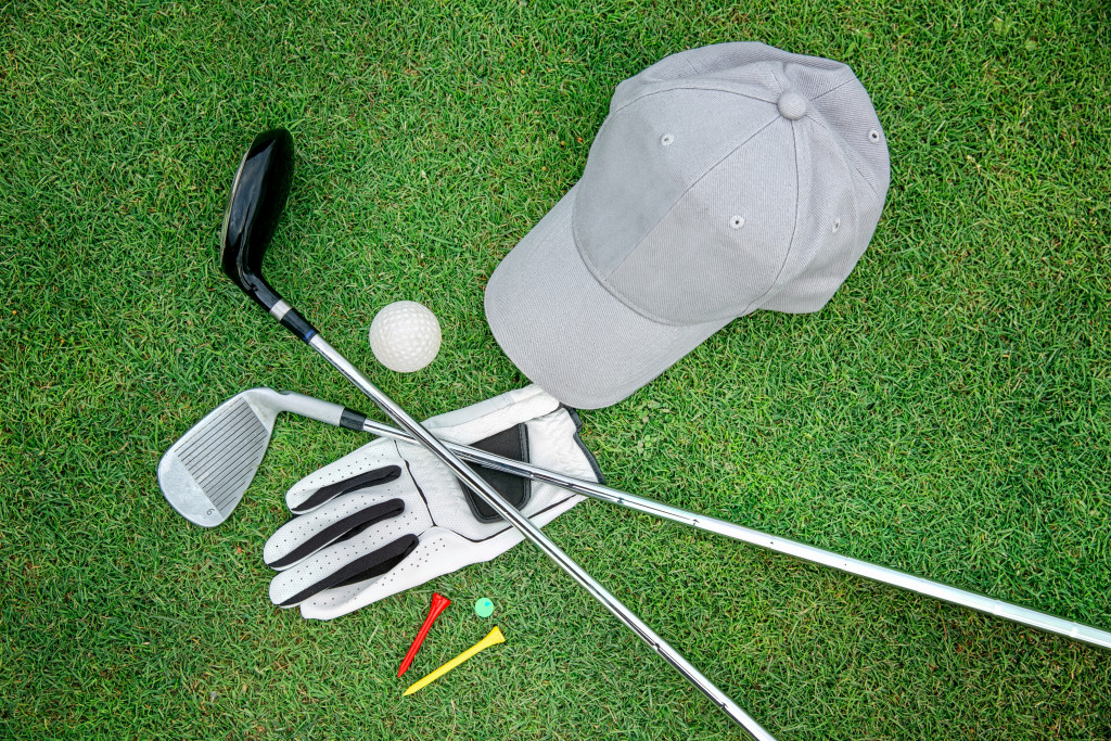 Golf equipment placed on green grass.