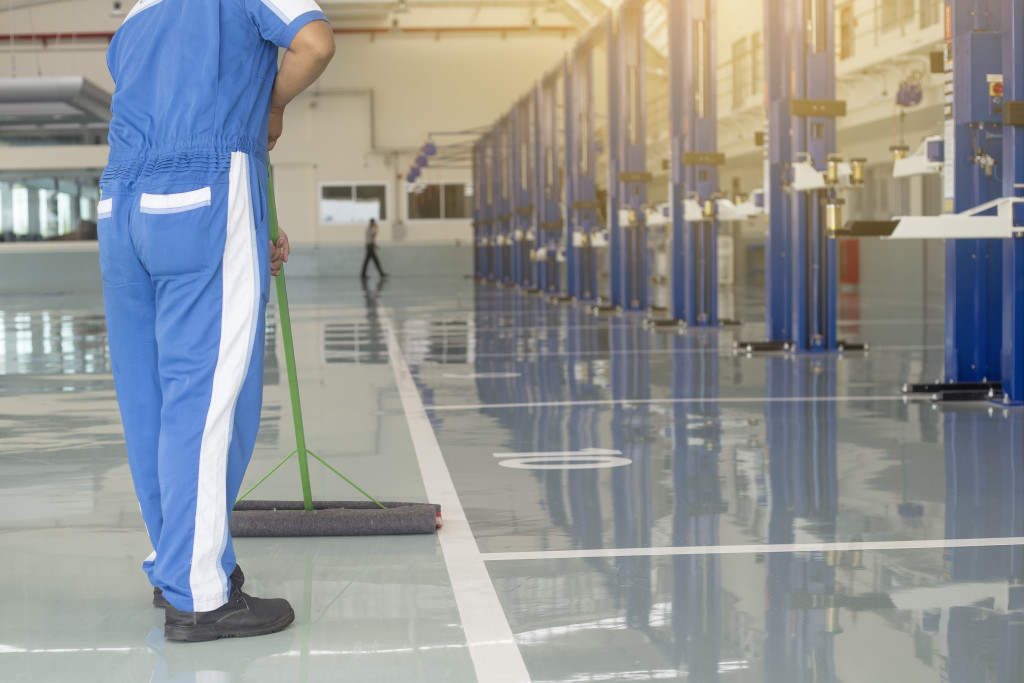 A worker cleaning the warehouse