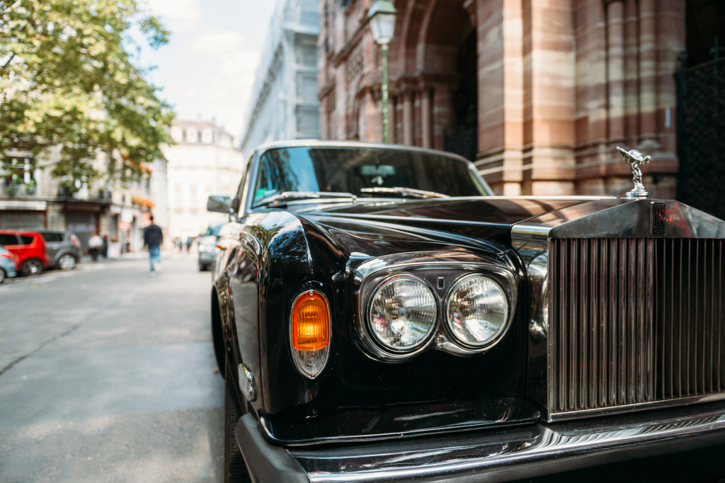 a black luxury car parked in a street