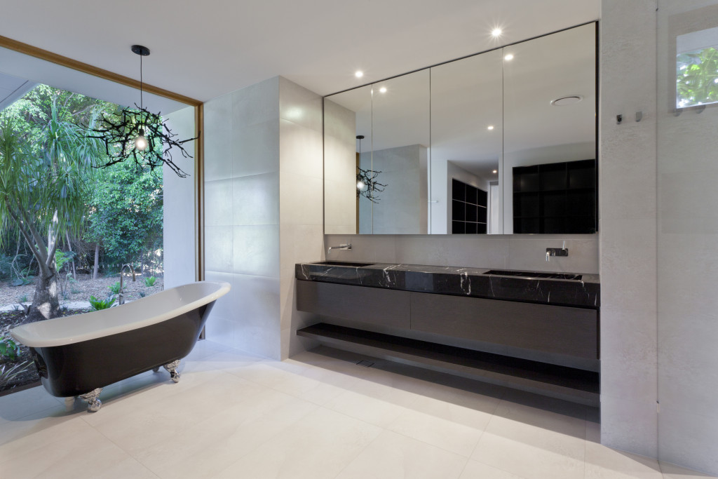 Luxury bathroom with mirror, sink and classic bathtub