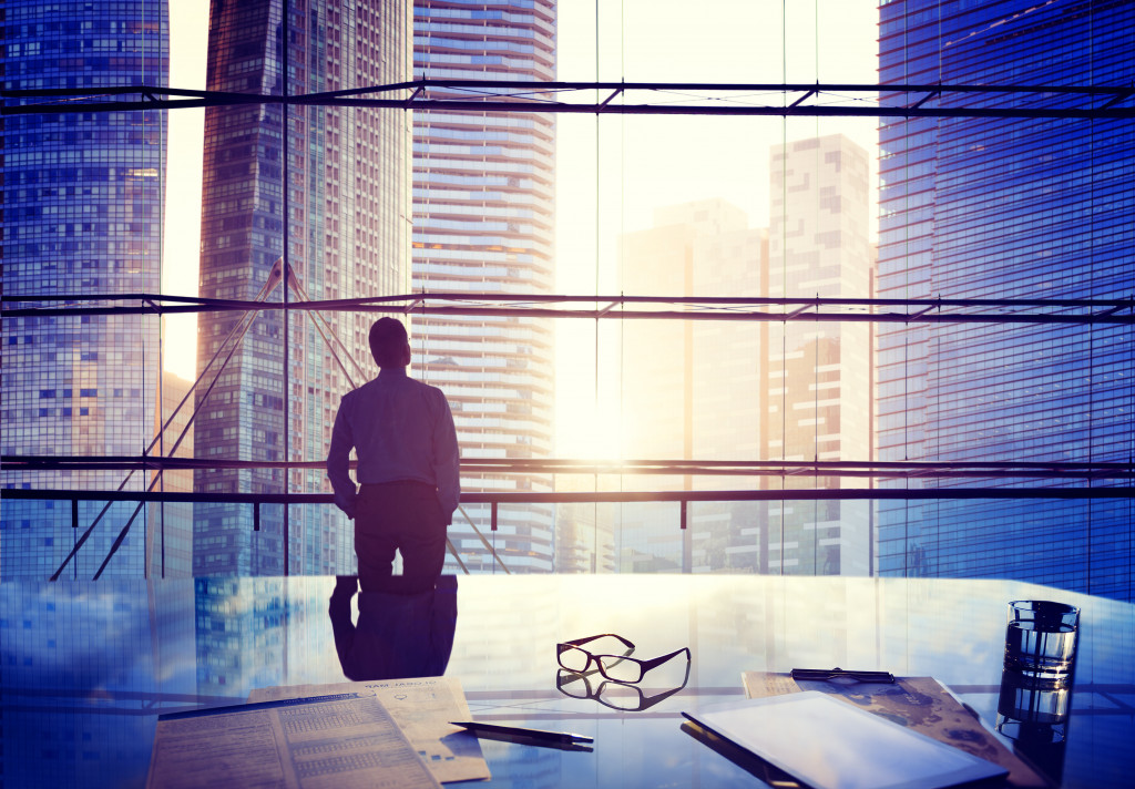 Successful businessman staring into buildings