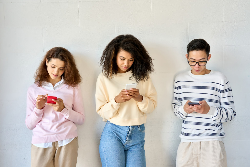 Teenagers using their mobile phone