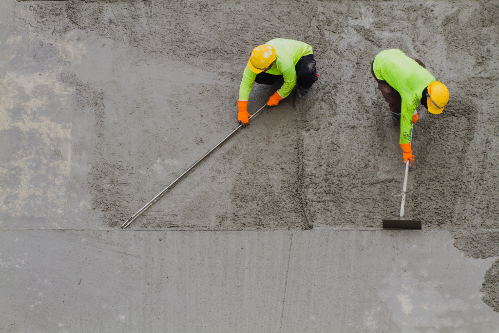 Workers flattening concrete